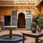 Morning view of Moroccan riad courtyard with fountain
